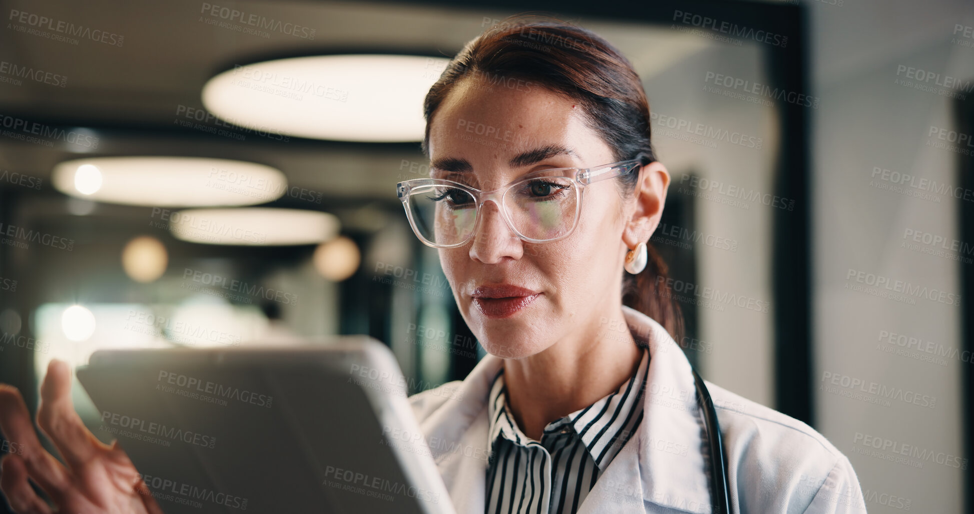 Buy stock photo Healthcare, doctor and woman with tablet in clinic, reading report or update records for insurance. Tech, serious and mature person in hospital for research, medical history and review schedule