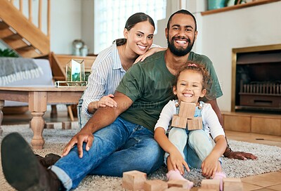 Buy stock photo Building blocks, growth and portrait with family in living room of home for cognitive game. Brain function, smile and wood puzzle of child and interracial parents in apartment for learning activity