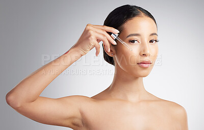 Buy stock photo Portrait, woman and skincare in studio with serum application, hyaluronic acid or hydration benefits. Person, dermatology and dropper with collagen oil, glowing skin or cosmetics on white background.