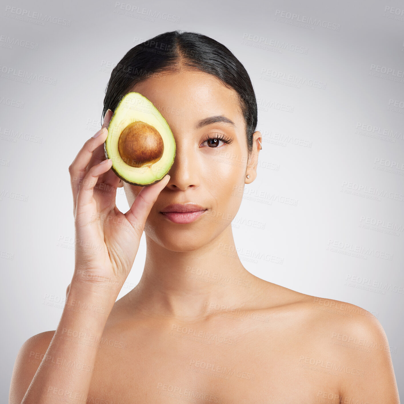 Buy stock photo Portrait, woman and skincare in studio with avocado, antioxidants and hydration benefits for beauty. Person, fruit and natural cosmetics with vitamin e, wellness and dermatology on white background.