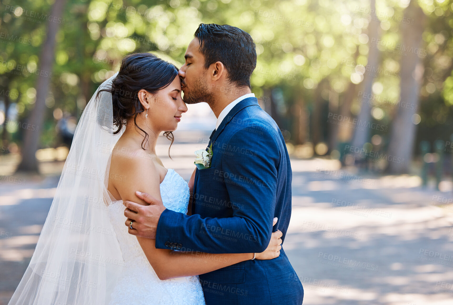 Buy stock photo Wedding, forehead kiss or couple in park with hug, trust or romantic moment in union ceremony. People, bride or groom outdoor with embrace, companion or emotional connection in marriage celebration.
