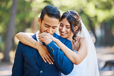 Buy stock photo Kiss, hands and couple at wedding outdoor for marriage, love or commitment in nature. Bride, groom and embrace for affection, trust and people with partner for support and connection in park 