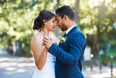 Buy stock photo Forehead, holding hands and couple at wedding outdoor for marriage, love or dance in nature. Bride, groom and embrace for affection, people or partner for support and connection with peace in park 