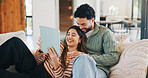 Couple, laughing and relax with tablet in lounge, streaming film and bonding with partner on weekend. Scroll, online and happy people with tech for entertainment, comedy and funny movies in house
