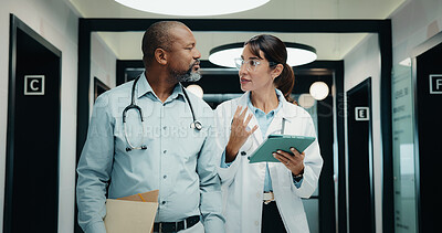 Buy stock photo Discussion, walking or doctors with tablet in hospital, care plan assistance or medical case advice. Talk, tech or mature people with specialist referral for treatment, patient diagnosis or teamwork