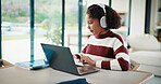 Laptop, education and child with headphones on video call in home for online class with elearning. Talking, technology and girl student with audio tech and computer for virtual lesson in house.