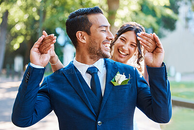 Buy stock photo Smile, bride and groom with surprise for wedding reveal, playful romance and interaction. People, laughing and blindfold gesture for couple anticipation, emotional reaction and marriage tradition
