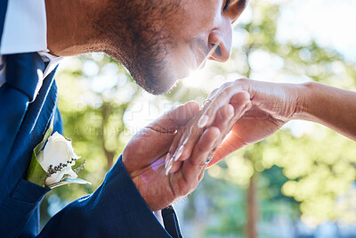 Buy stock photo Man, wedding and outdoor to kiss hand for love, marital commitment or loyalty promise to wife. Groom, bride and affection in nature for marriage celebration, garden event or flare with couple support