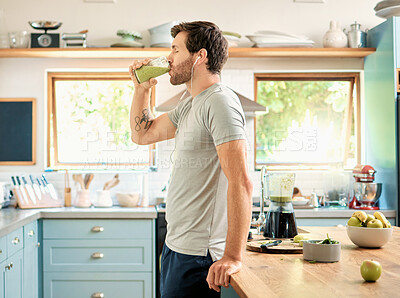 Buy stock photo Wellness, earphones and man in kitchen with smoothie, organic juice and protein shake for gut health. Diet, person and audio tech in home with green drink, supplement and nutritional tips in podcast