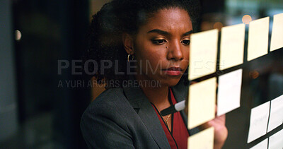 Buy stock photo Night, writing and black woman at glass wall with sticky note, brainstorming or plan for audit deadline. Space, auditor and businessperson work late in office with strategy, problem solving and idea.