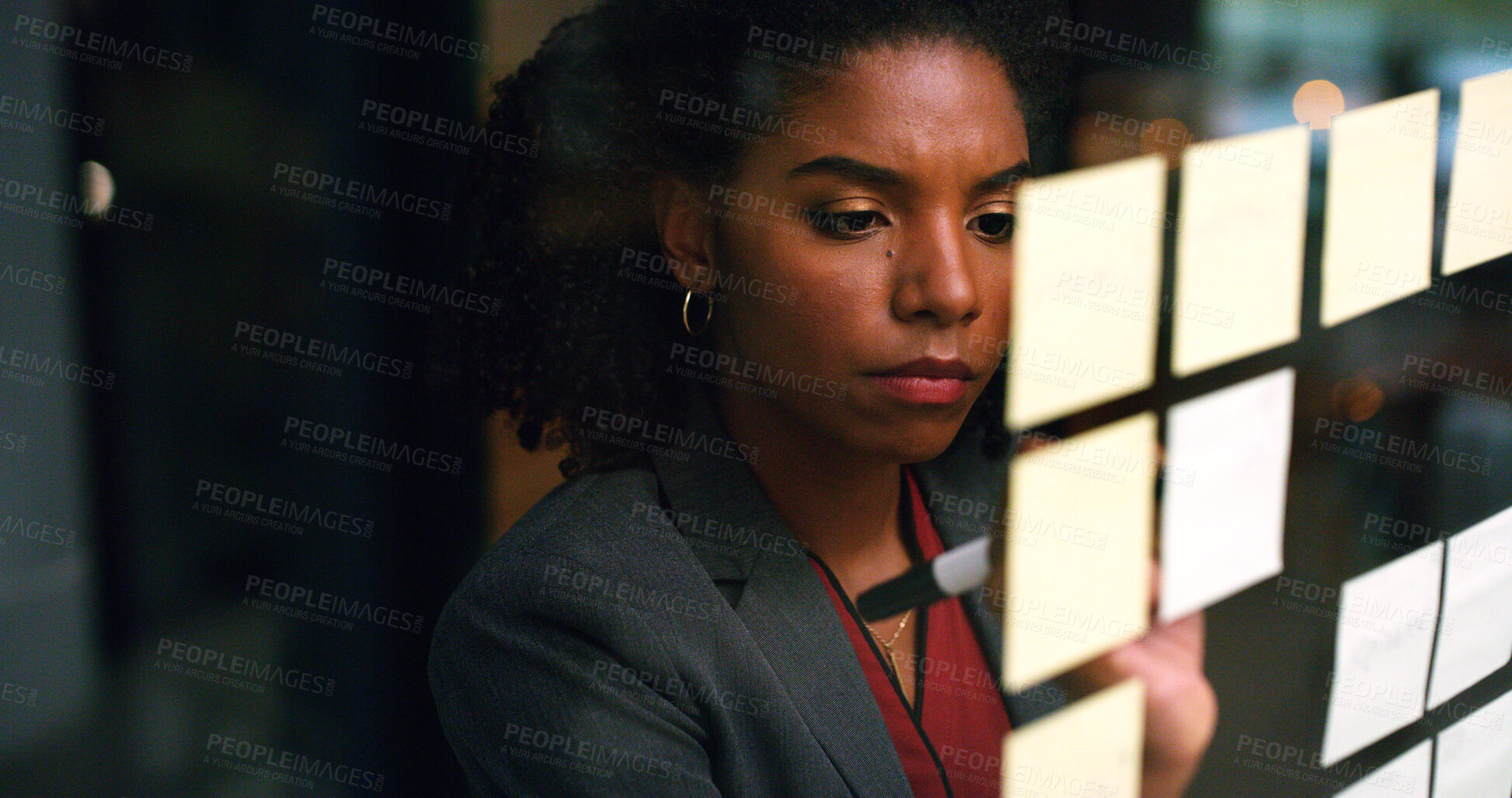 Buy stock photo Night, writing and black woman at glass wall with sticky note, brainstorming or plan for audit deadline. Space, auditor and businessperson work late in office with strategy, problem solving and idea.