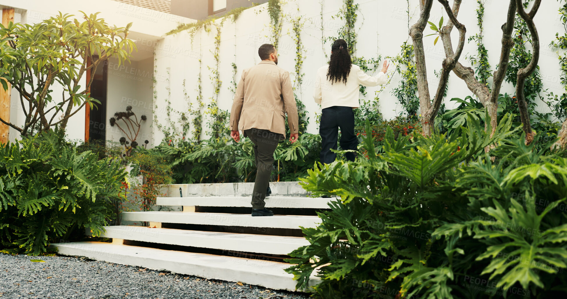 Buy stock photo Back, estate agent and tour with client walking for home investment or property view. Finance, mortgage and rental apartment with man speaking to realtor woman outdoor for advice, consulting or sale