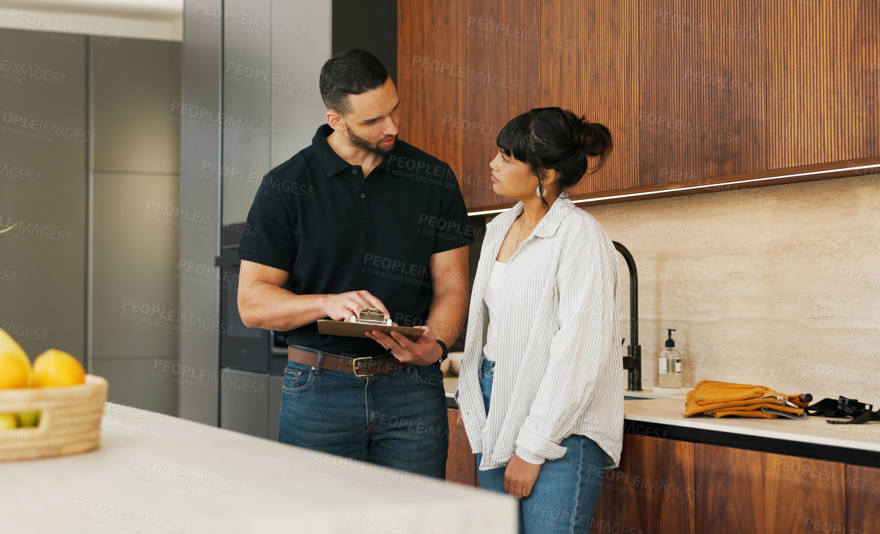 Buy stock photo Clipboard, discussion and handyman with woman in kitchen for maintenance, service or home renovation. Installation, inspection or man with checklist for client information, insurance or invoice