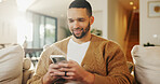 Phone, relax and man in home for text message, online dating and social media notification on sofa. Smile, mobile and person at living room for communication, matching and check profile on internet