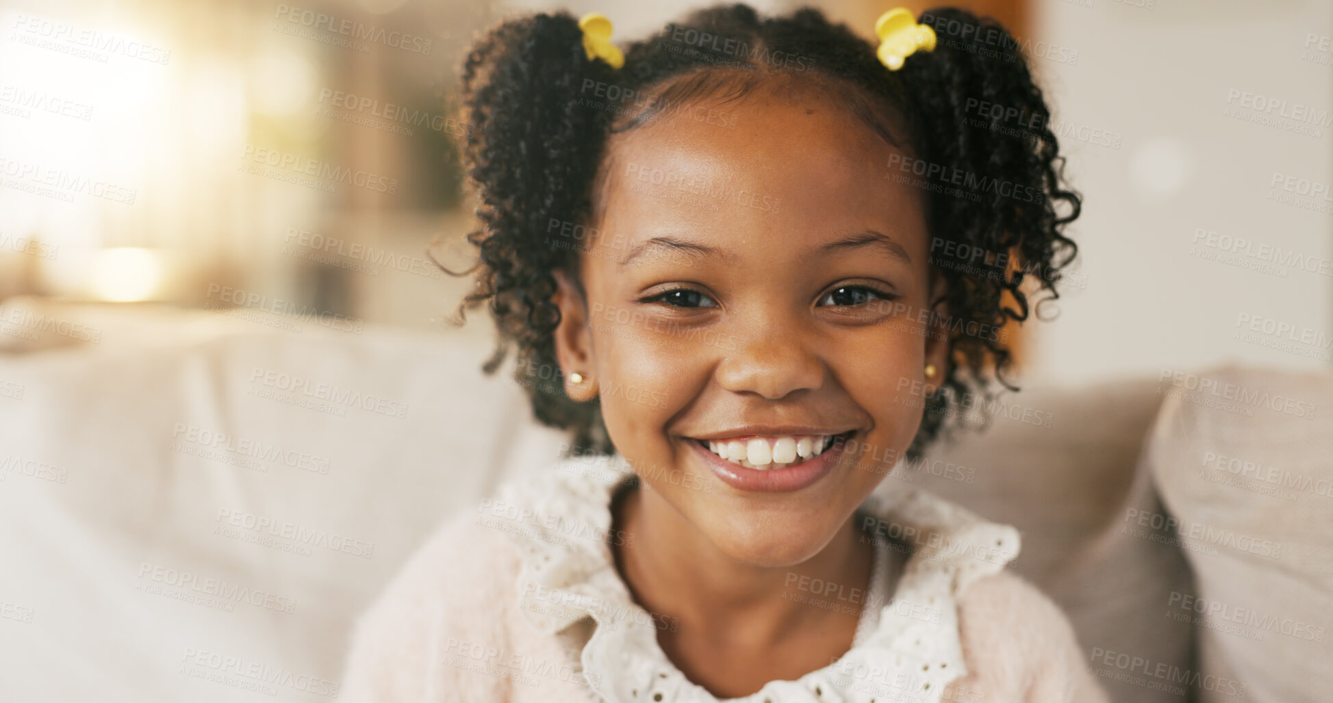 Buy stock photo Portrait, child and relax on sofa with smile, positive attitude or childhood development in living room. Happy, young African girl and adorable kid in home with growth, comfortable and weekend break.