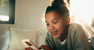 Buy stock photo Relax, reading and girl with mobile in bedroom, social media app and connection for browsing internet. Smile, rest and child with phone for message platform, watch video and streaming movie in home
