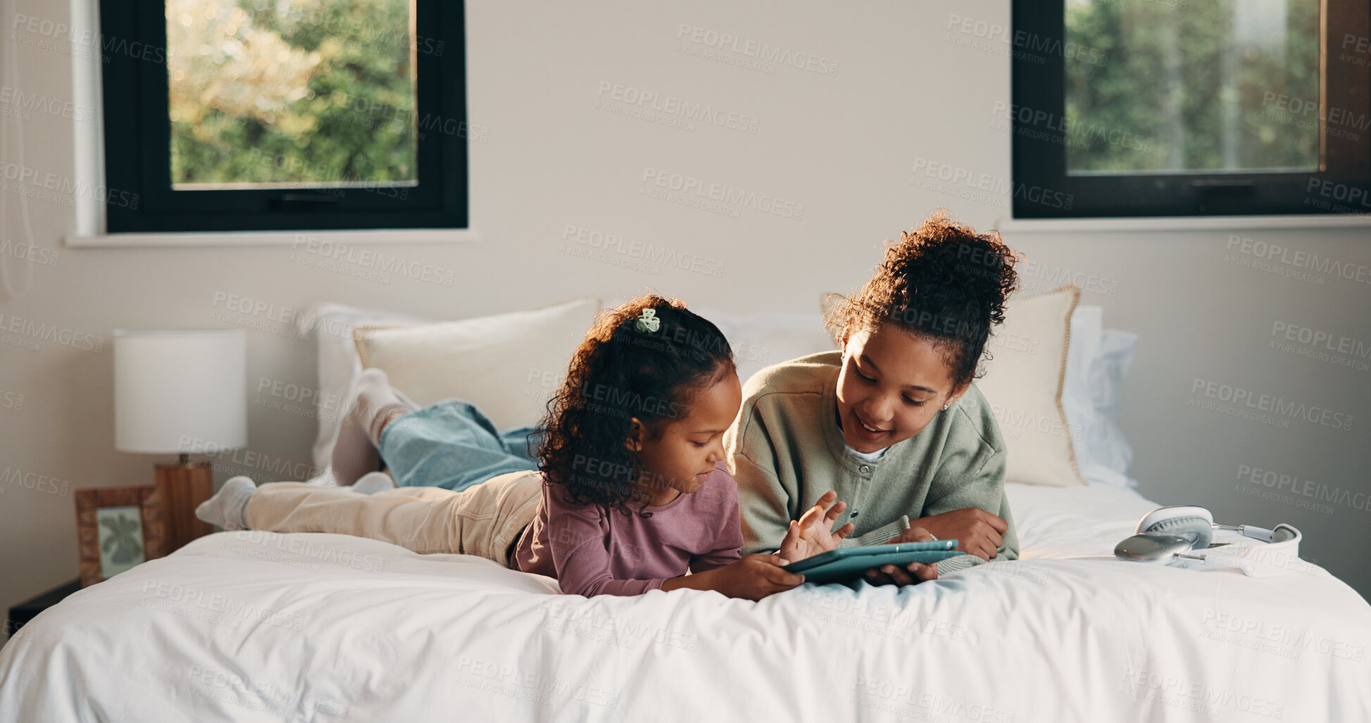 Buy stock photo Relax, smile and tablet with happy kids on bed in home for holiday, morning break or weekend. App, comfortable and streaming with girl children in bedroom of apartment for development or growth