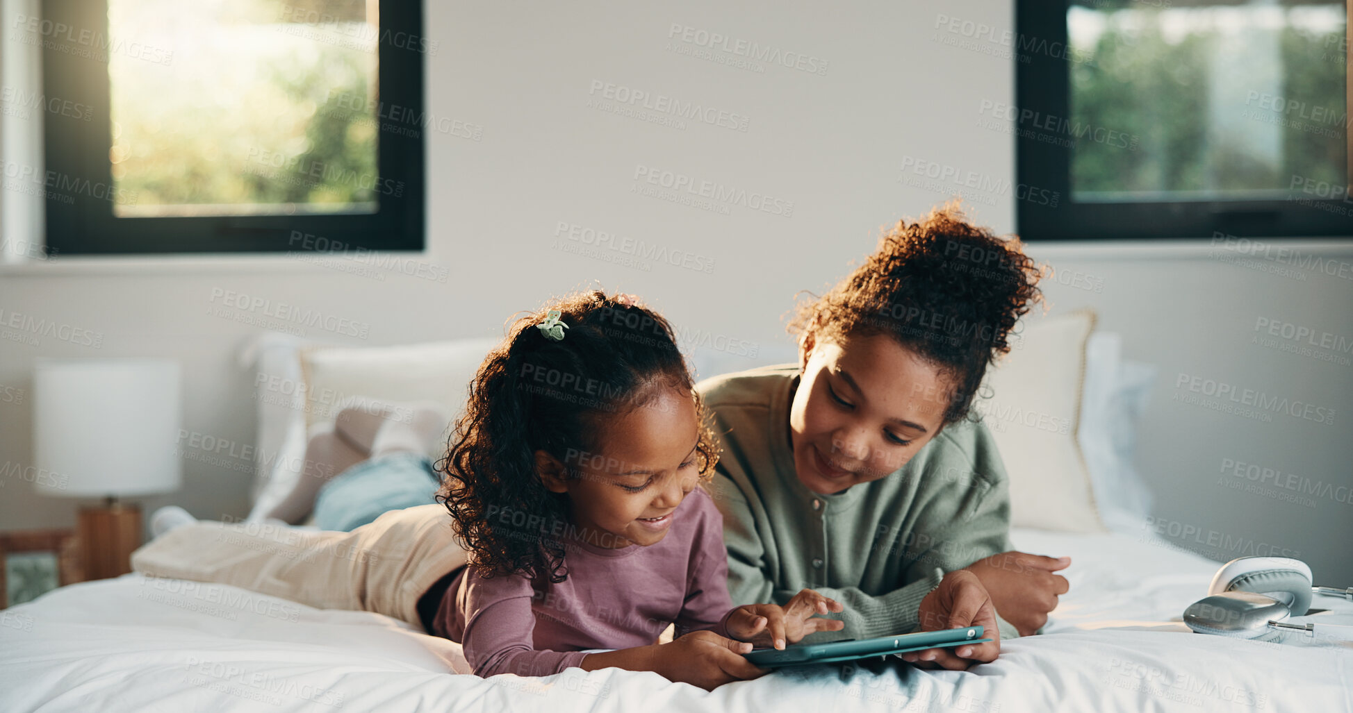 Buy stock photo Relax, children or girls with tablet in bedroom, watch cartoon or streaming video for weekend bonding. Family subscription, movie website or sisters with tech for film platform, happy or rest in home