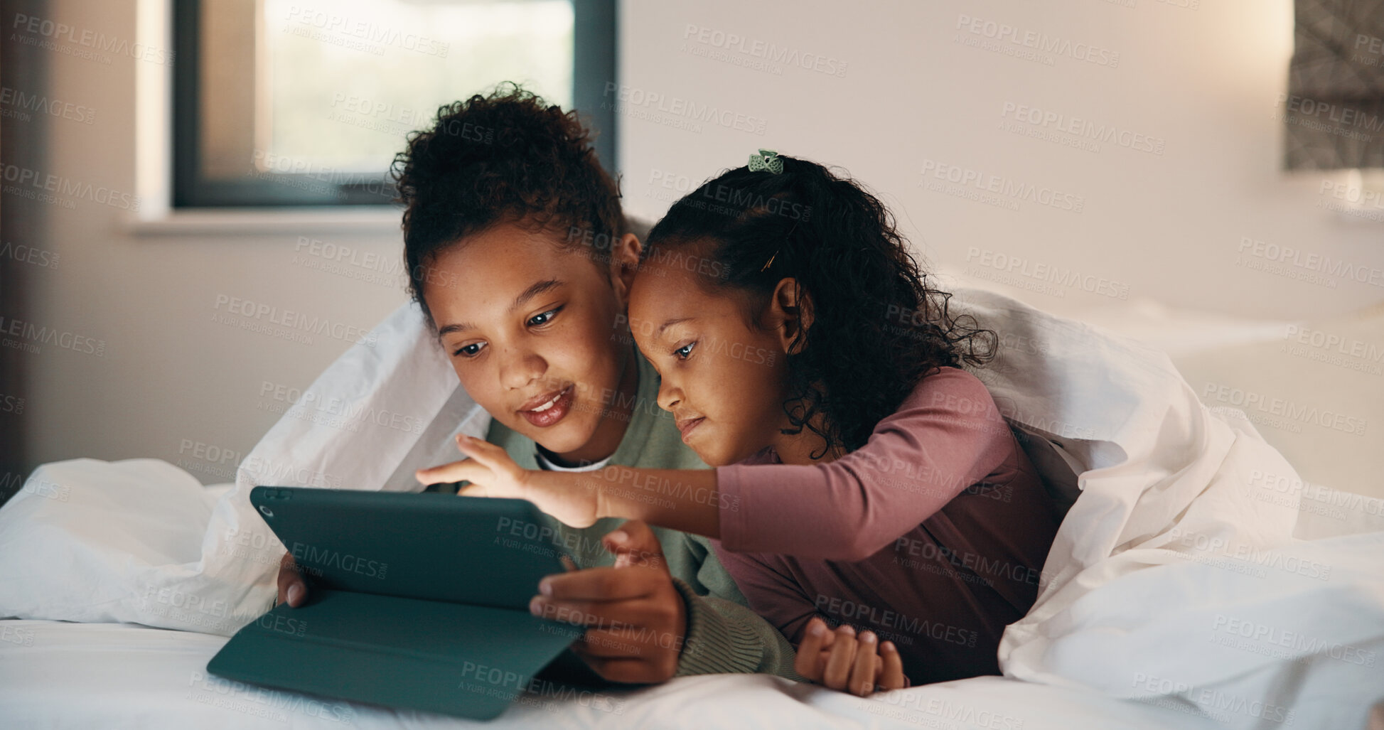 Buy stock photo Relax, children and sisters with tablet in bedroom, watch cartoon and streaming video for bonding. Family subscription, movie website and girls with tech for film platform, smile and rest in home