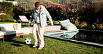 Soccer, ball and kick with child outdoor for playing, playoff practice and game drills. Football sport, match training and weekend break with kid in backyard of home for growth, fun and footwork