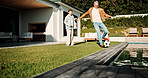 Soccer, kick and father with son outdoor for bonding, support and teaching game. Football, connection and weekend break with man and child in backyard of family home for growth, fun and care together