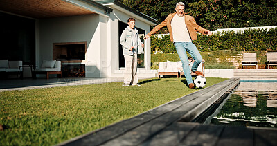 Buy stock photo Soccer, kick and father with son outdoor for bonding, support and teaching game. Football, connection and weekend break with man and child in backyard of family home for growth, fun and care together