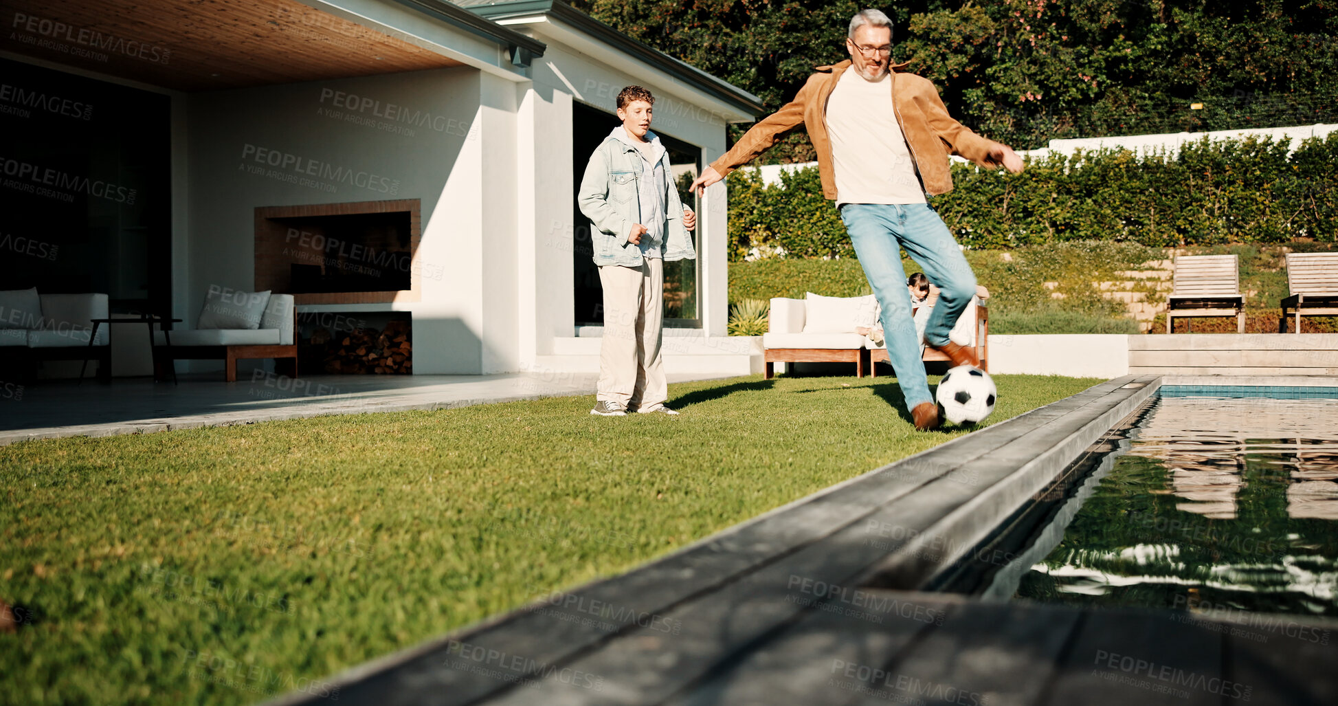 Buy stock photo Soccer, kick and father with son outdoor for bonding, support and teaching game. Football, connection and weekend break with man and child in backyard of family home for growth, fun and care together