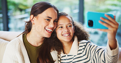 Buy stock photo Mother, child and smile in home for selfie, status update and bonding for relationship memory. Social media, mom and daughter in living room for photography, profile picture and care with connection