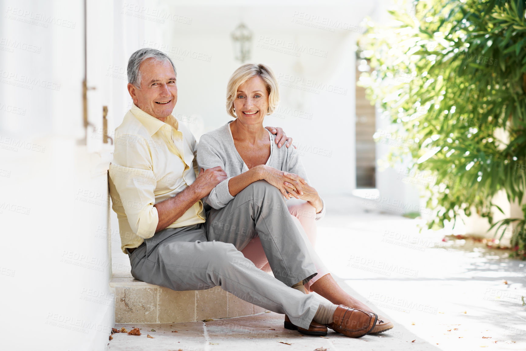Buy stock photo Portrait, old couple and relax at resort for travel, love and bonding together for summer holiday. Smile, senior people and embrace on step for fresh air, partner affection and commitment on vacation