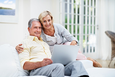 Buy stock photo Portrait of a senior couple using a laptop while relaxing in the lounge