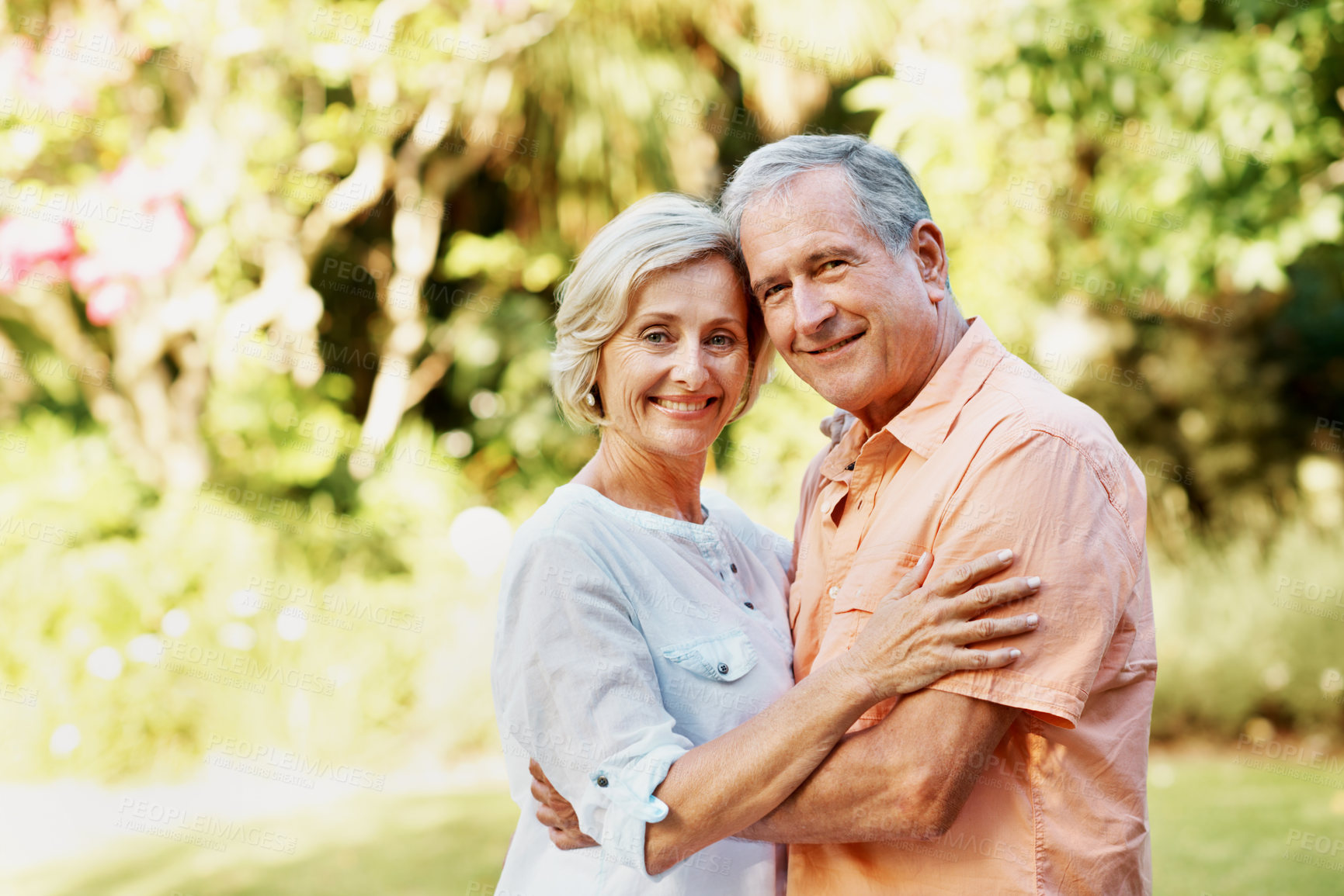 Buy stock photo Senior, couple and happy in park for portrait, love and affection for relationship wellness in marriage. Woman, man and hug in nature or garden, smile and care with relax together in retirement