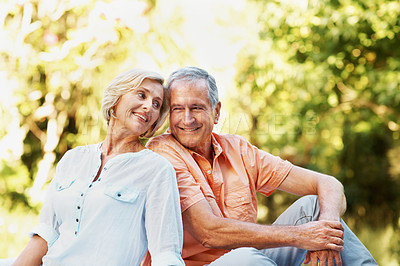 Buy stock photo A happy senior couple relaxing in their garden on a lovely summer's day