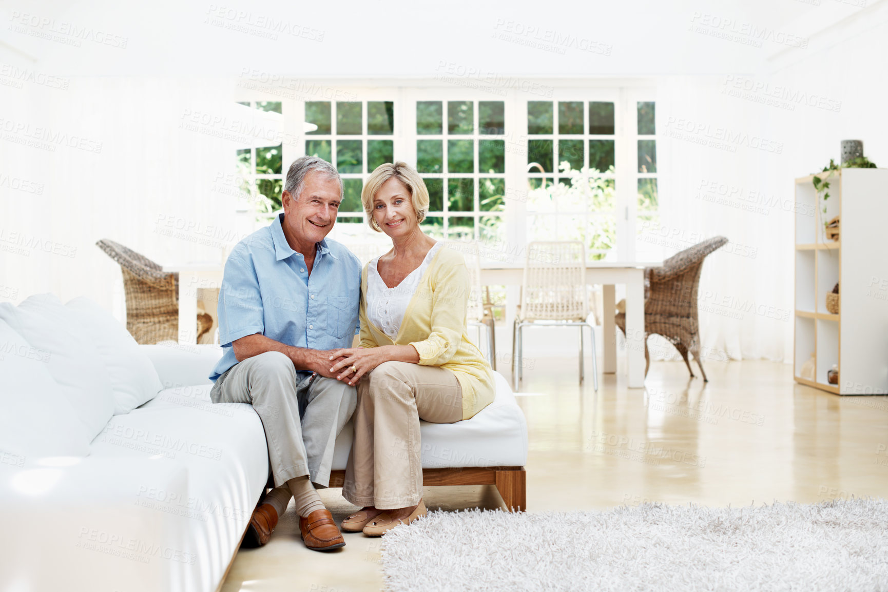 Buy stock photo Smile, holding hands and portrait with old couple on sofa in home for bonding, connection and marriage. Support, weekend break and retirement with senior man and woman in living room for loyalty
