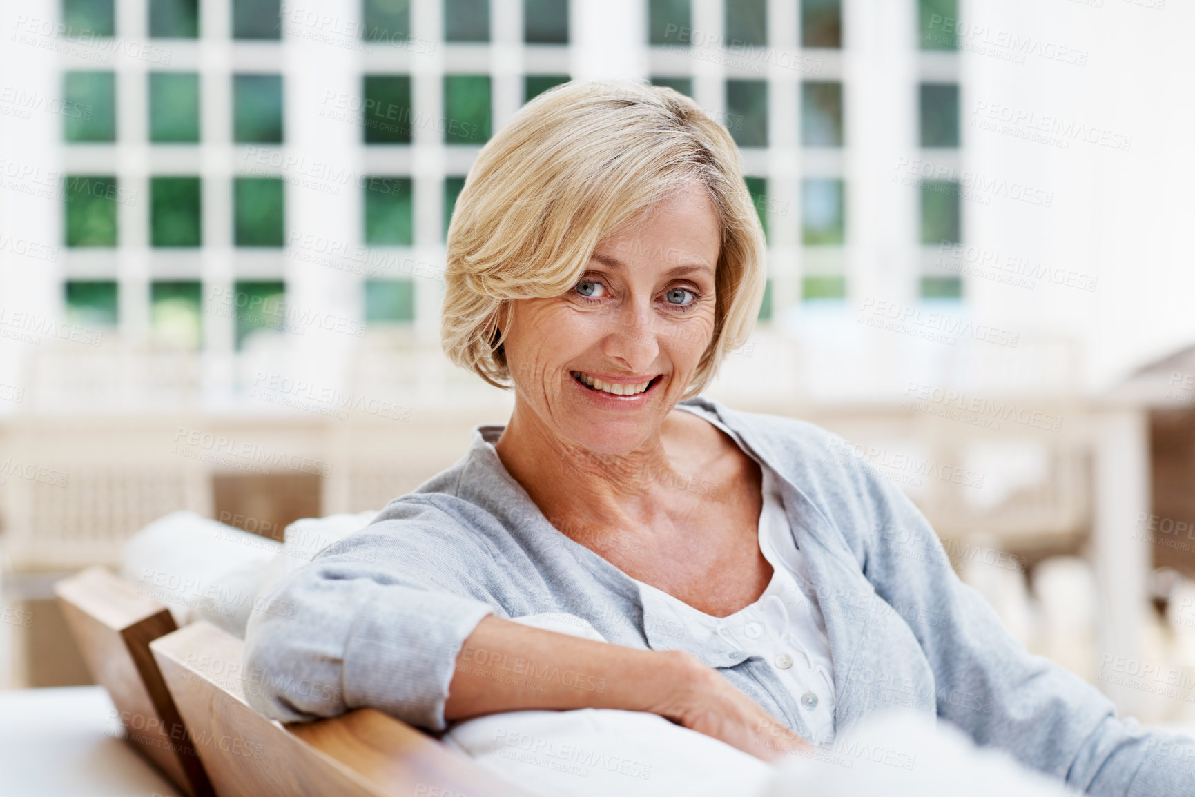Buy stock photo Smile, calm and portrait of old woman on sofa in home for weekend break, pride and wellness. Confidence, retirement and happy with senior person in living room in apartment for satisfaction and relax