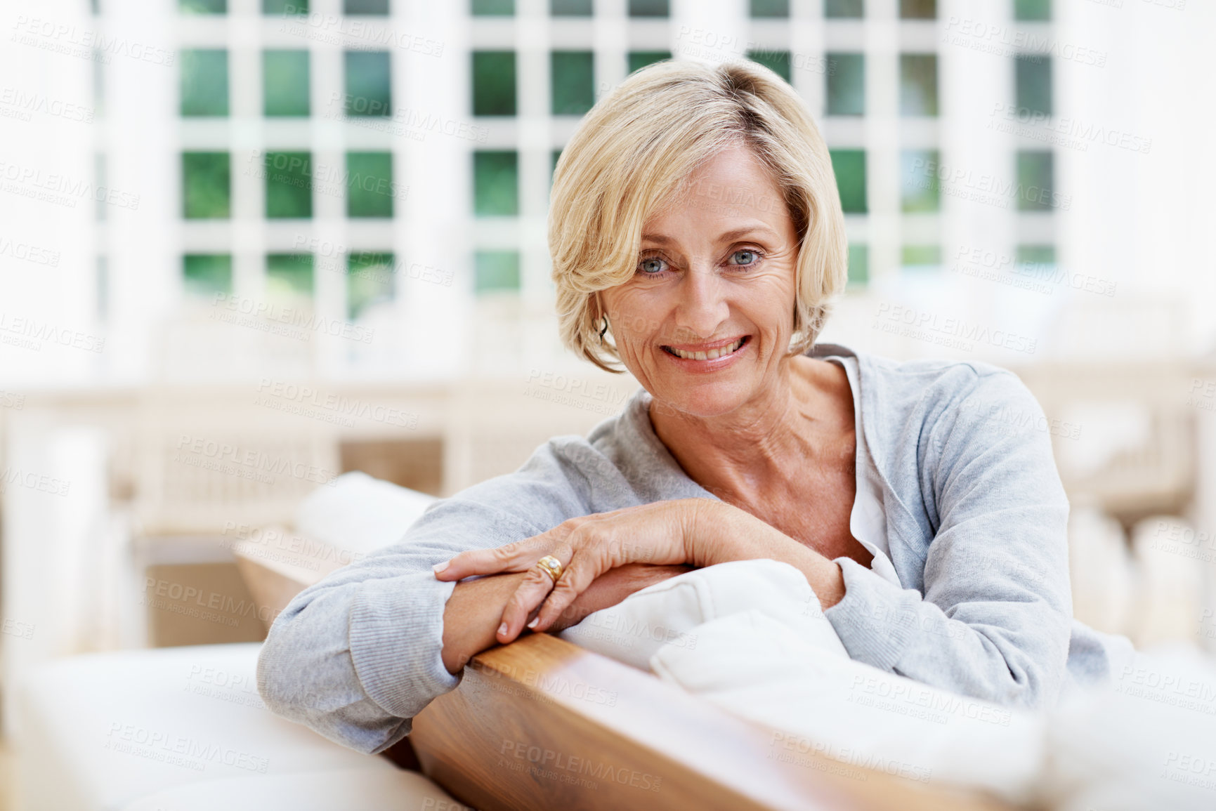 Buy stock photo Smile, pride and portrait of old woman on sofa in home for weekend break, relax and wellness. Confidence, retirement and happy with senior person in living room in apartment for satisfaction and calm