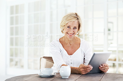 Buy stock photo A smiling senior woman holding a digital tablet while sitting outside with a cup of coffee  copyspace