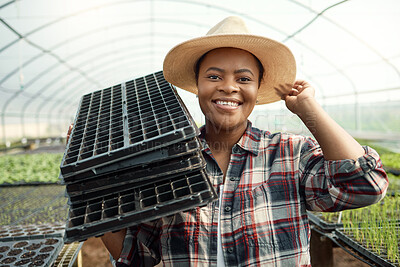 Buy stock photo Woman, farmer and portrait in greenhouse with trays, seedling care and sustainable business. Black person, smile and farming with efficiency for growth, crop development and agriculture with hat