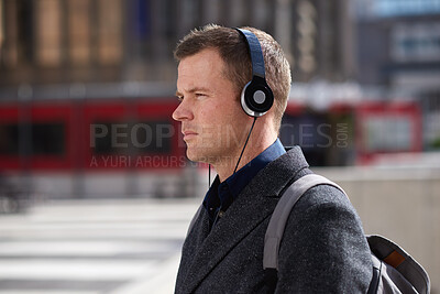 Buy stock photo Commuting, businessman and serious with headphones in city, online or listening to financial podcast. Outdoor, asset manager and person with tech on street, walking and streaming audio in morning