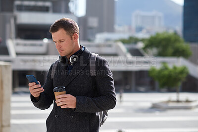 Buy stock photo Businessman, travel and texting with phone in city, online and reading investment update on website. Serious, asset manager and person with coffee on street, commuting and communication on mobile