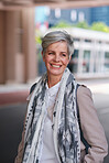 Portrait mature business woman smiling confident successful female in urban city wearing scarf success testimonial