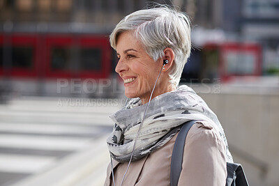 Buy stock photo Commuting, businesswoman and happy with earphones in city, online or listening to financial podcast. Outdoor, asset manager and mature person with tech on street, walk and streaming audio in morning