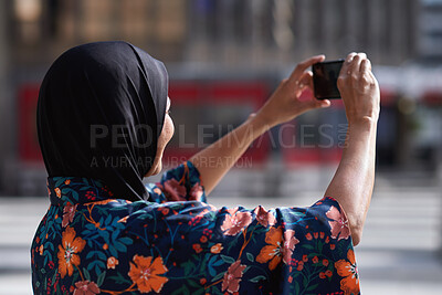 Buy stock photo Travel, photo and Muslim woman in city, phone to capture memory and summer holiday for break. Outdoor, mobile user and person with social media, post update and vacation with live streaming in Canada