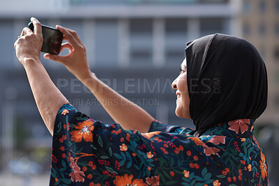 Buy stock photo Travel, photo and Muslim woman in city, phone to capture memory and vacation for break. Outdoor, mobile user and person with social media, post update and sightseeing with live streaming in New York