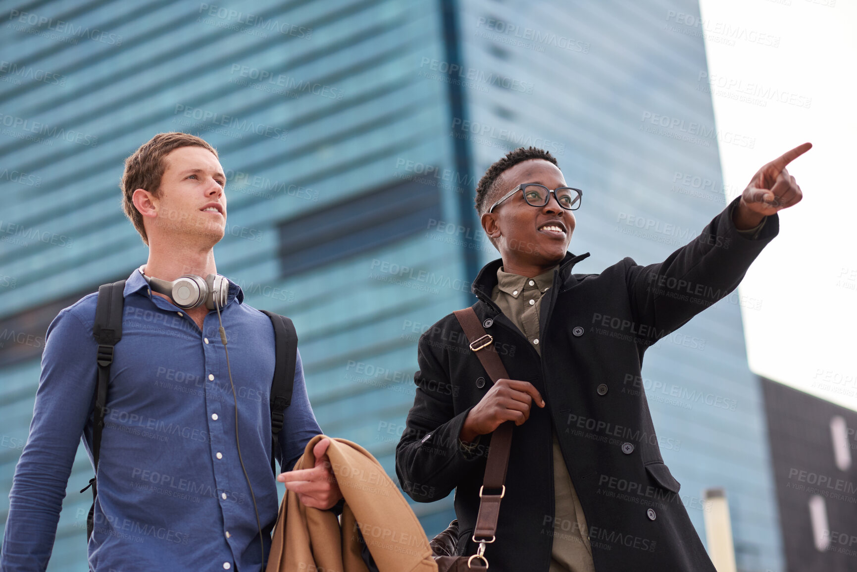 Buy stock photo Commute, friends and business people with pointing in city, morning bonding and direction to work. Travel, coworkers and happy men with discussion in urban town, sightseeing and low angle for support