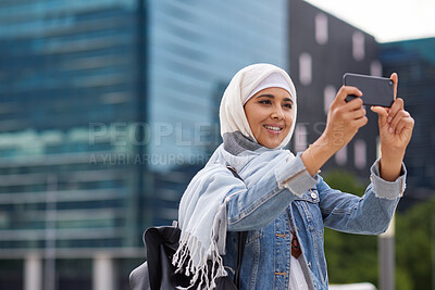 Buy stock photo Muslim woman, phone and picture in city, holiday and capture memory for vacation adventure outdoor. Islamic person, mobile and photography in town for sightseeing, social media update and smile