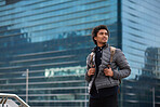 Portrait mixed race businessman in city smiling confident wearing backpack commuting