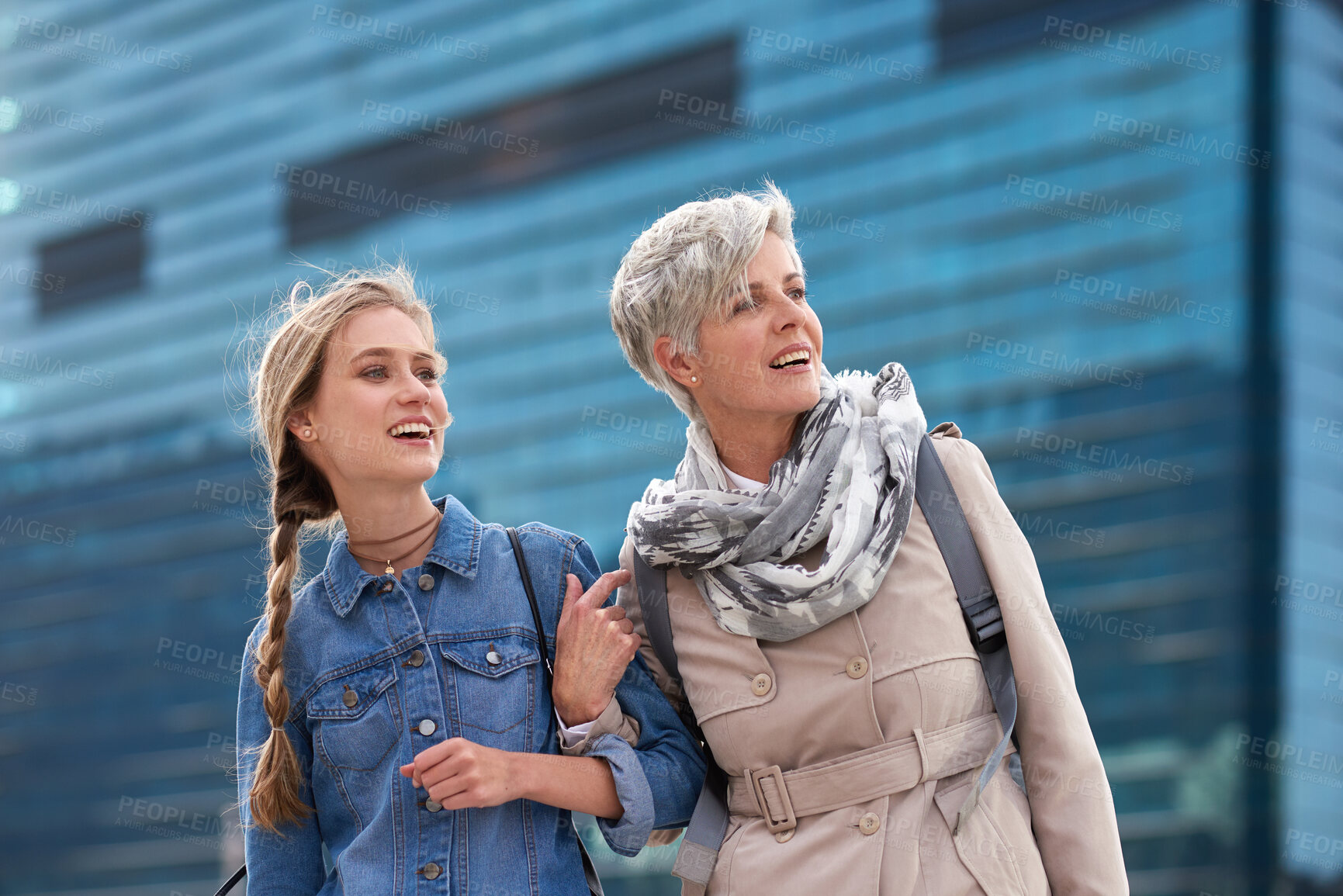 Buy stock photo Mom, travel and adult daughter in city with smile, holiday and bonding together on weekend break. Happy, mature parent and women explore in urban town with building, family connection and support.