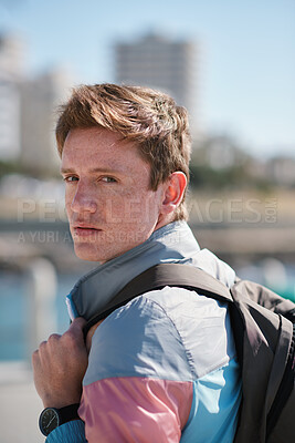 Buy stock photo Portrait, man or student in city with backpack, commute or university education for development. Serious, person and outdoor in urban town with bag, ambition or travel to college for knowledge growth