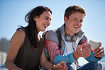 Mother and son using smartphone by the beach watching entertainment online young man bonding with mom on summer day