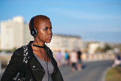 Buy stock photo Headphones, beach and black woman on holiday with listening to music, playlist or radio. Promenade, audio tech and female person streaming album by ocean on summer vacation, getaway or weekend trip.